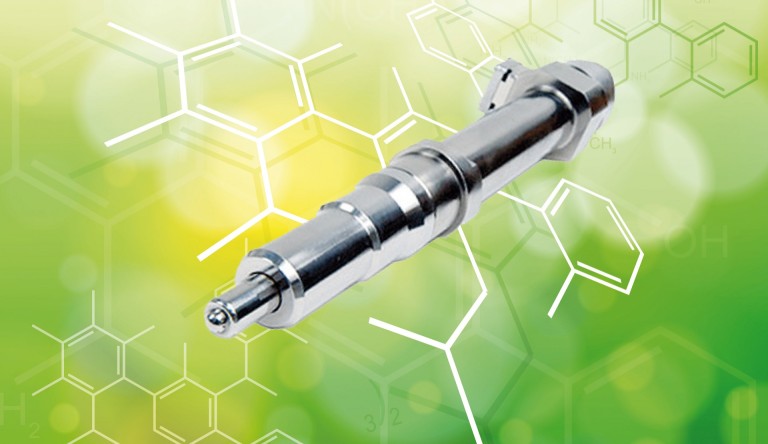 Bauteil Injektor vor grünem Hintergrund